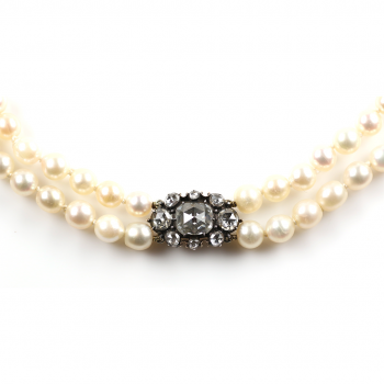 A mixed natural and cultured pearl necklace to a diamond encrusted clasp